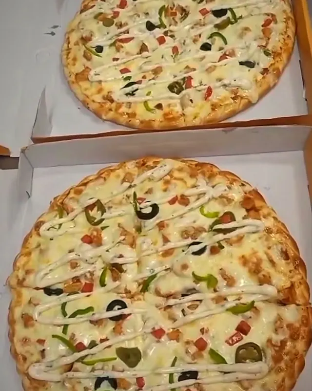 Two pizzas boxed and ready
